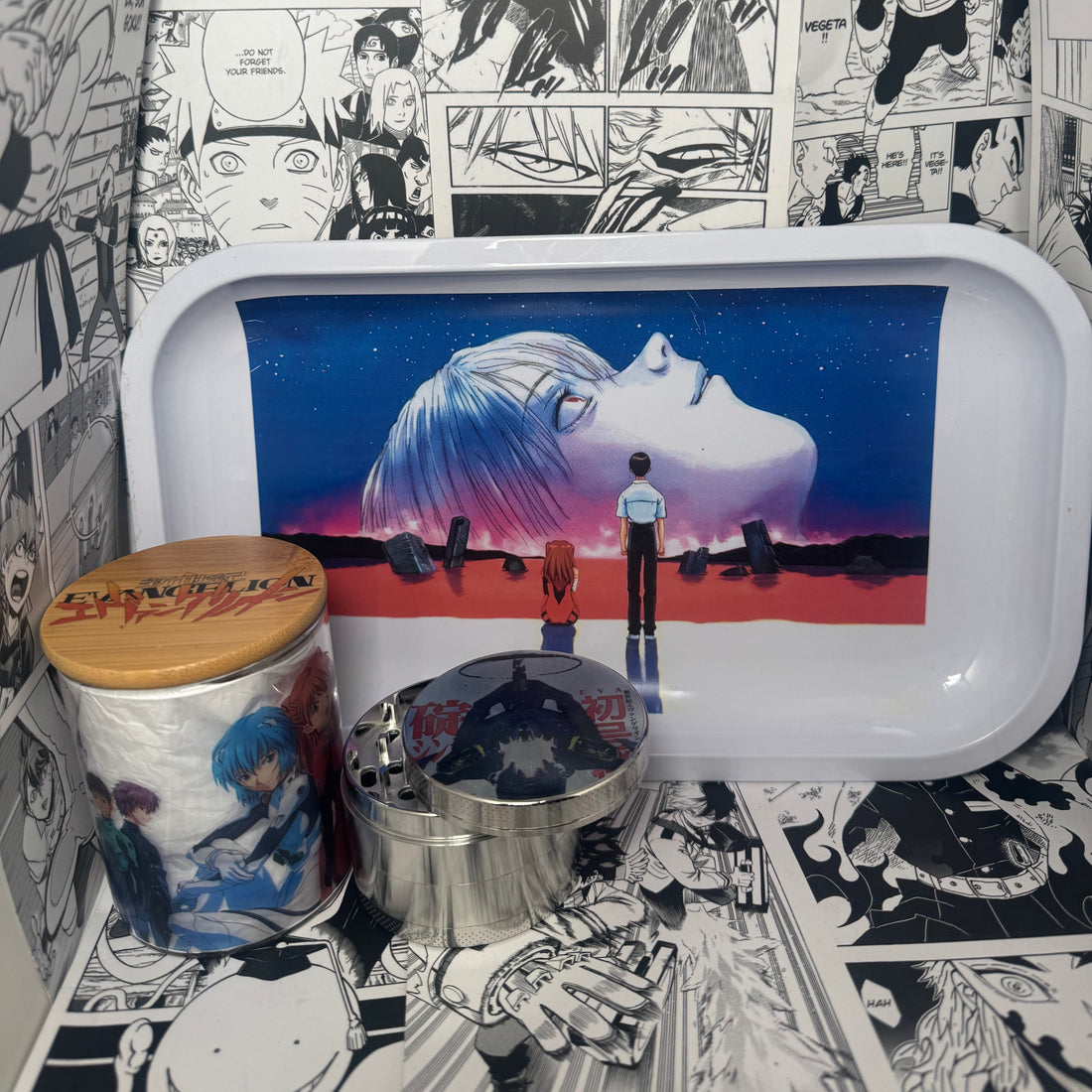 The SpicedAnime Evangelion 13 Grinder, Jar, Rolling Tray Set includes an anime scene art tray with a manga panel backdrop, plus a matching airtight bamboo jar and metal grinder featuring Evangelion character designs.