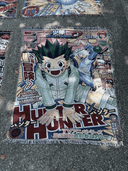 The Hunter X Hunter Anime Hand Woven Cozy Rug by SpicedAnime features vibrant manga cover art of Gon Freecss with bold Japanese text—ideal as a unique anime gift, tapestry throw, or cozy blanket for your home.